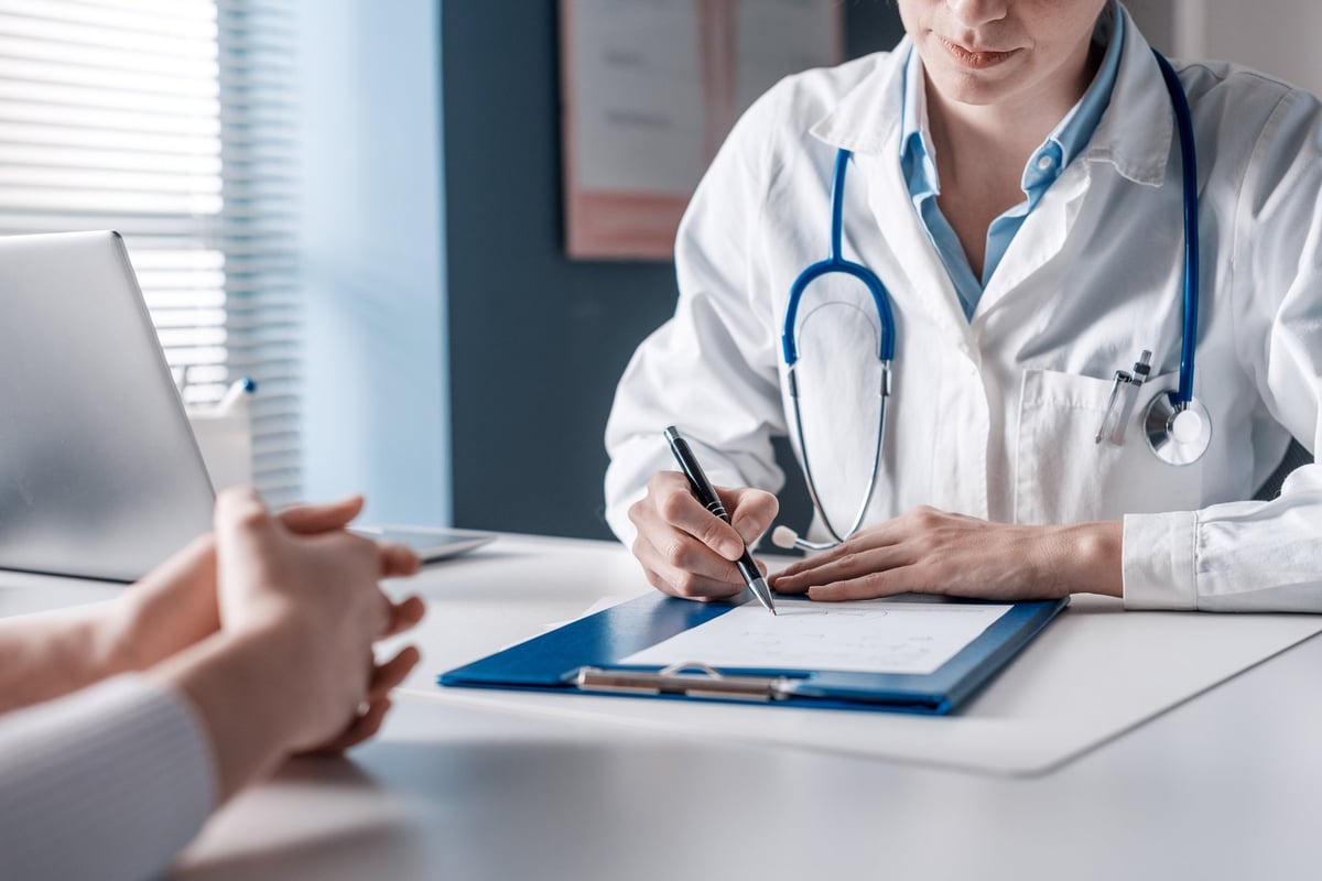 Doctor in consultation with patient discussing medical treatment