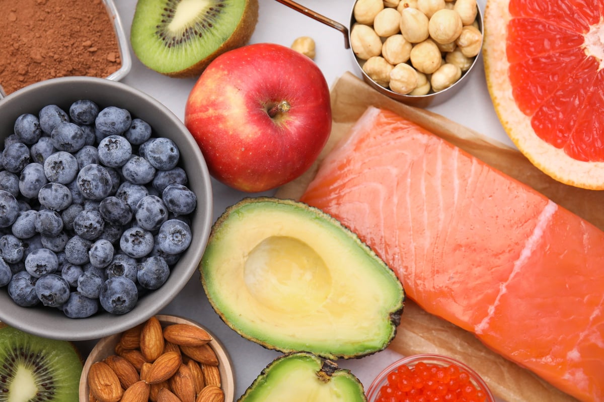 Many different healthy products on white table, natural sources of serotonin and anti-inflammatory nutrients