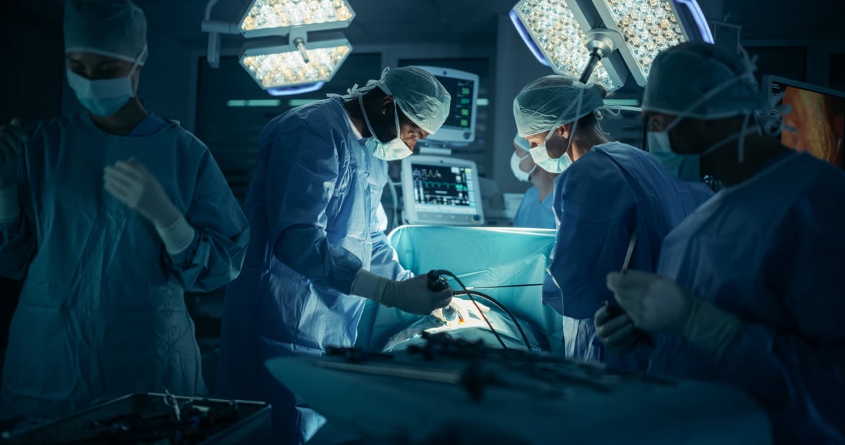 Diverse team of healthcare professionals performing surgery with extreme concentration, uniting skills to perform the procedure