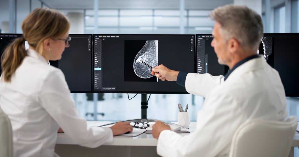 Two doctors analyzing medical results on computer screen